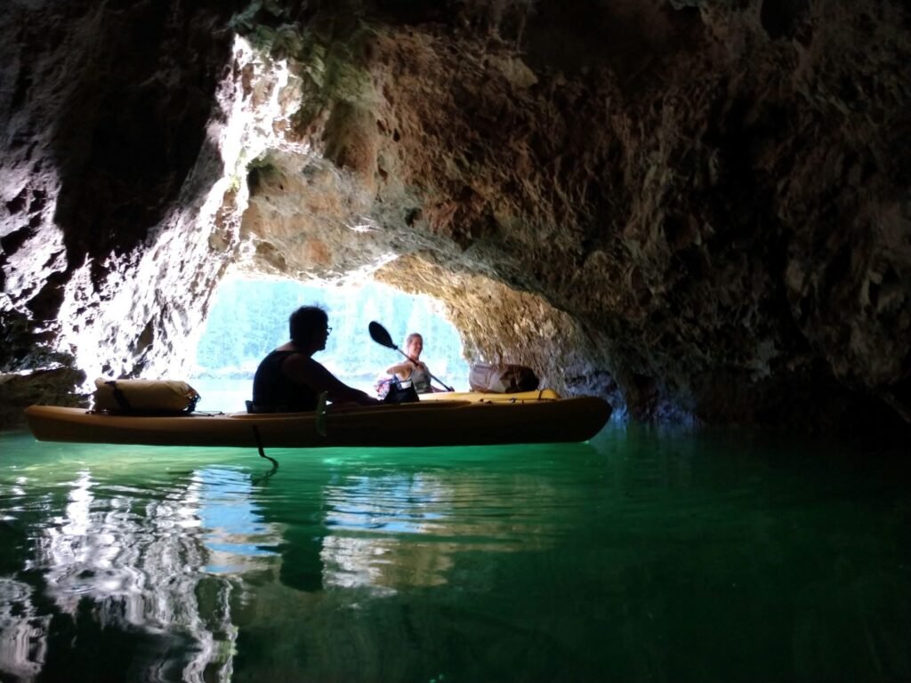 Two kayakers floating in a small cave the Pend Oreille River.