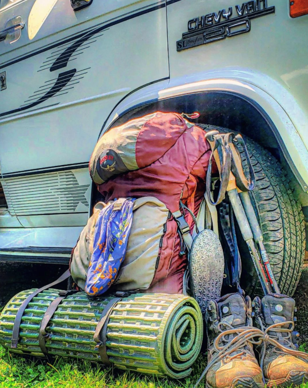 Author's backpack for her volunteer trail work, leaning against her Chevy van mobile art studio.
