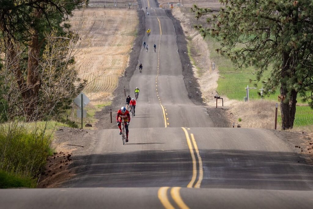 Cycling riding on rolling country road in rural area near Spokane during the Lilac Century Ride.