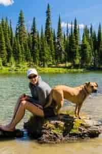 Hiker and her best friend taking a break at Ten Lakes Scenic Area. Photo: Aaron Theisen