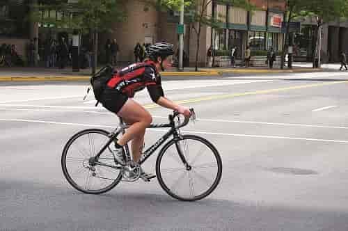 Jaime Kenney pedals on her way back to Jimmy John's for another delivery. Photo: Hank Greer