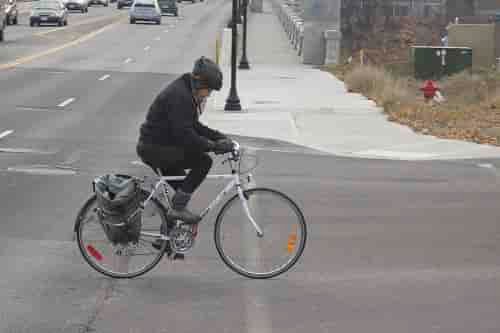 Cyclist crossing Monroe towards Kendall Yards.