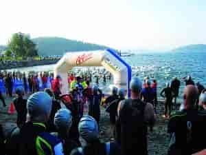 Triathlon swim racers on the beach at Lake Coeur d'Alene ready to start the race.