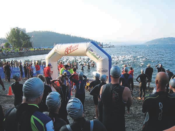 Triathlon swim racers on the beach at Lake Coeur d'Alene ready to start the race.