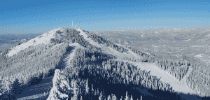 Skyline view of Silver Mountain, with snowy trees and ski runs.