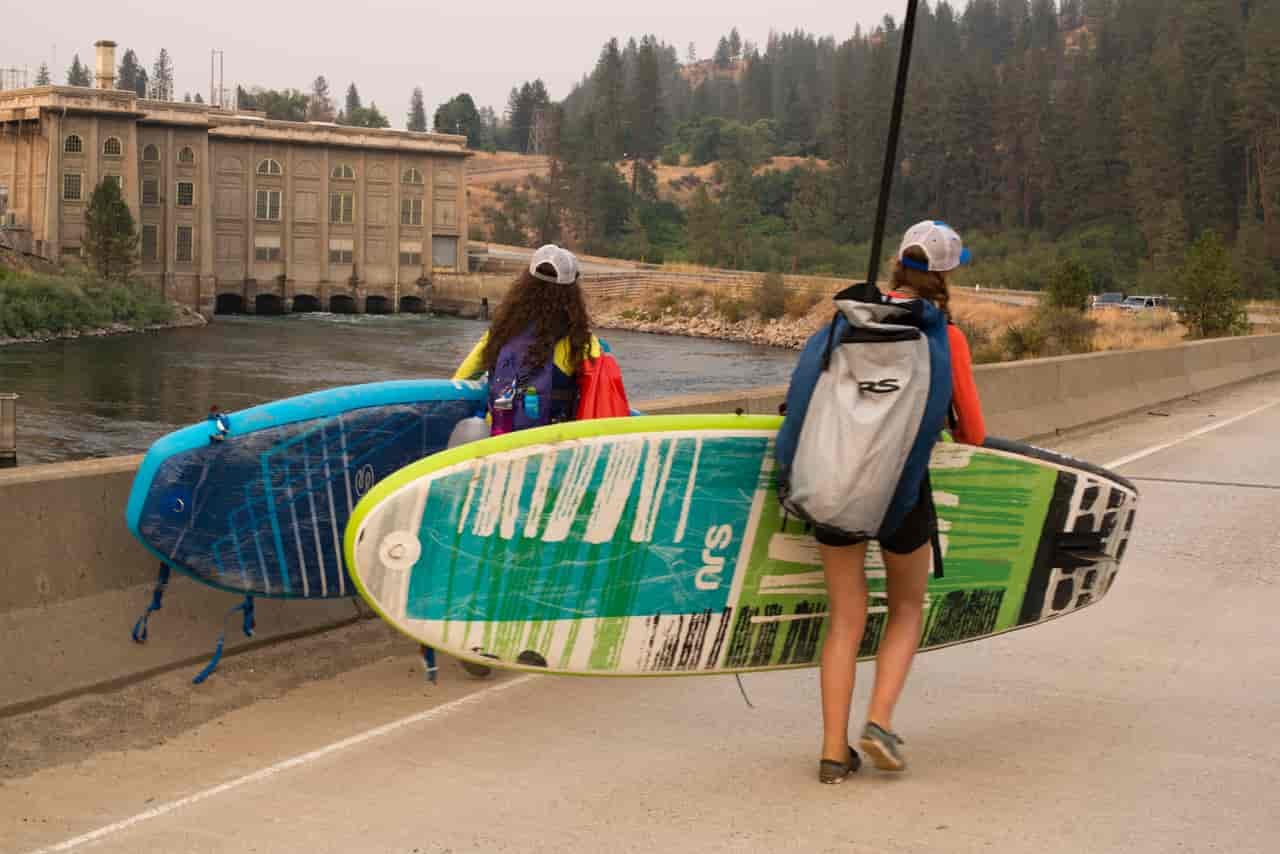 The girls portage their stand up paddle boards (Photo: Jed Conklin Photography)