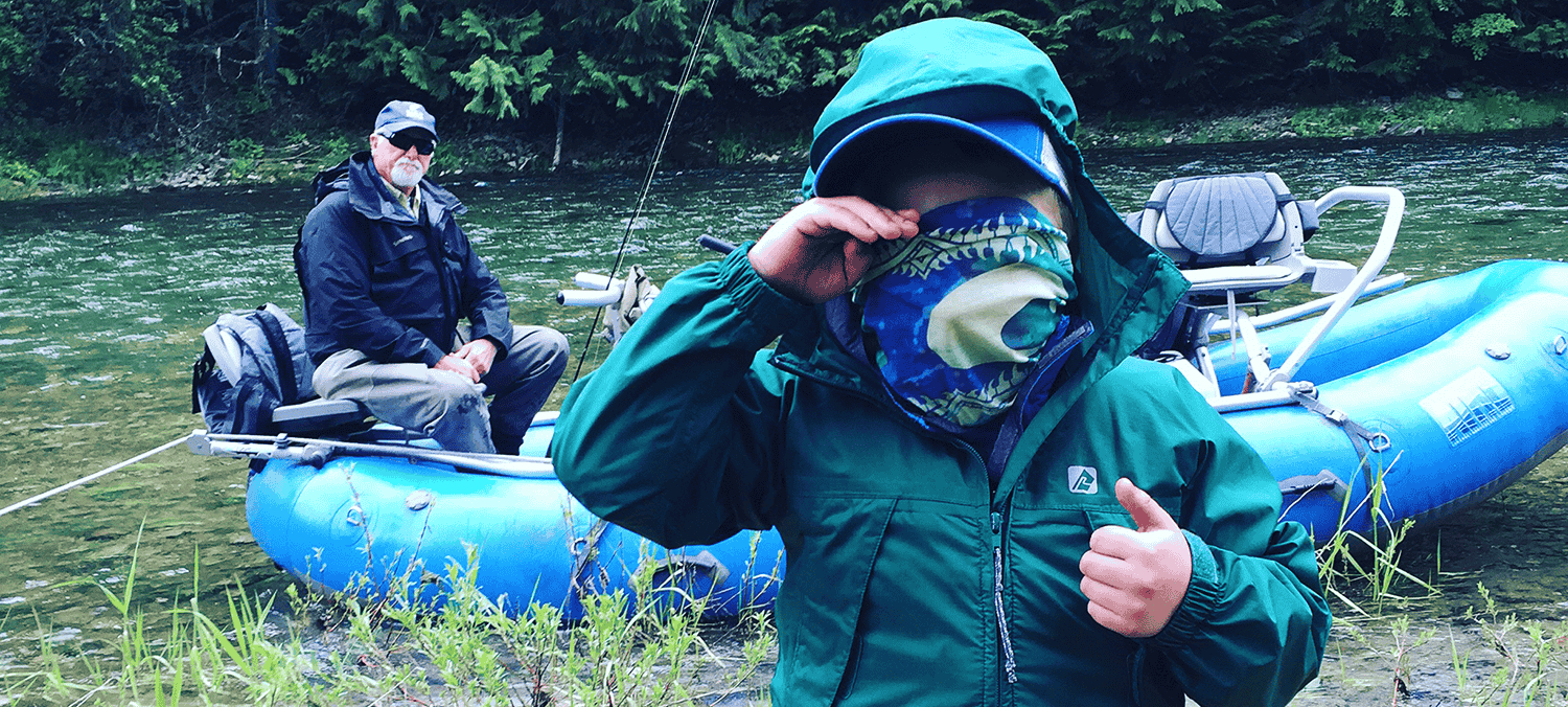 Photo of young boy and grandfather along the river edge.