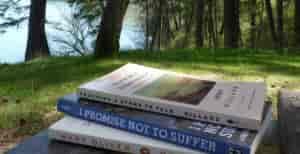 photo of three books on a bench.