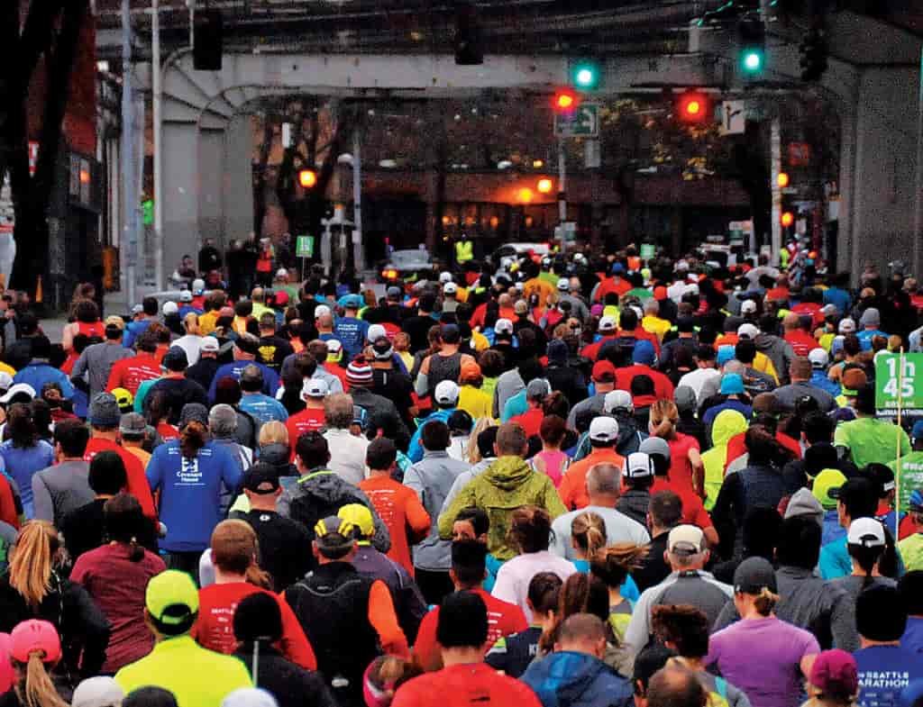 Photo of racers running under an overpass in Seattle.