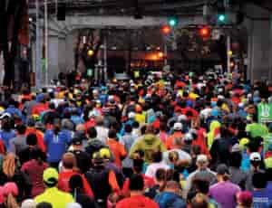 Photo of racers running under an overpass in Seattle.