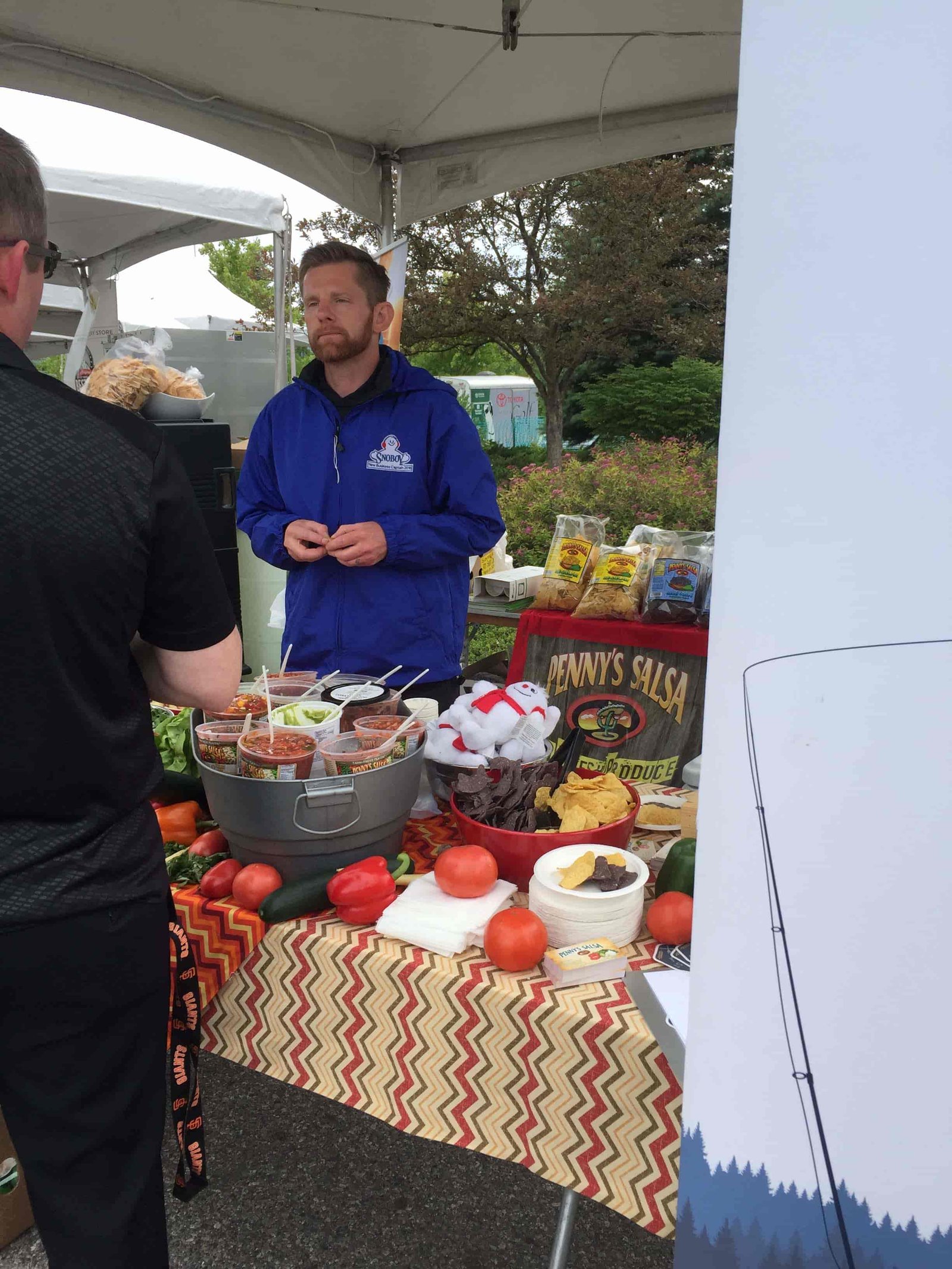 Table full of samples of Penny's Salsa