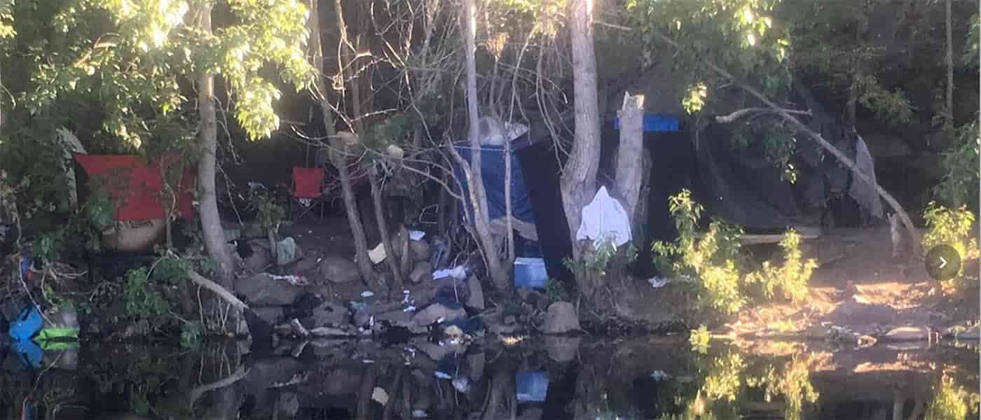 Photo of trash along the Spokane River shoreline.