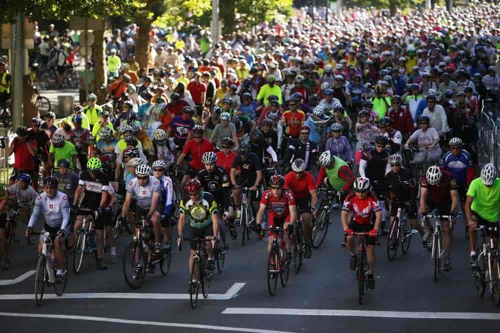 A massive group of bicyclers take off at the start line of SpokeFest