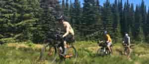 Photo of three bikers descending Chilco Mountain via single track.
