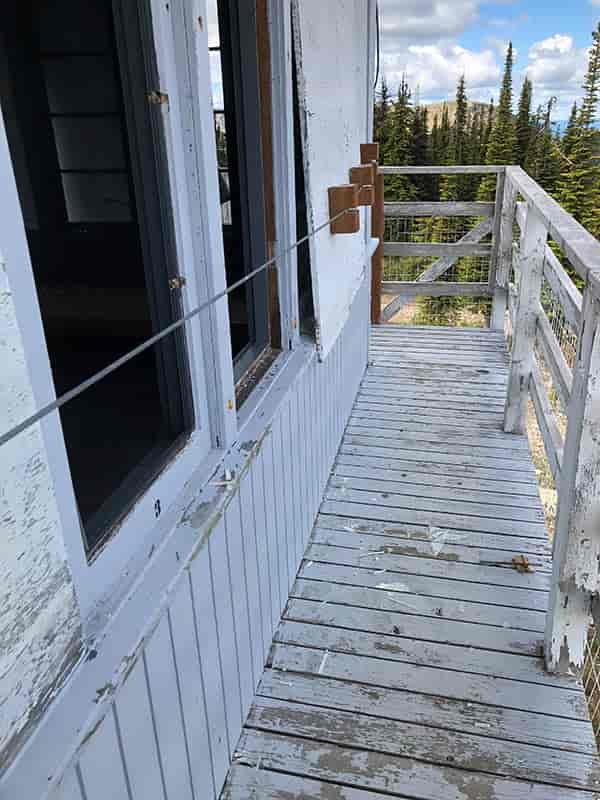 Photo of broken windows on a fire lookout tower.