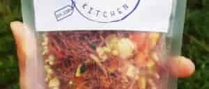 Photo of person's hand holding a bag of freeze dried corned beef hash from Bushka's Kitchen.