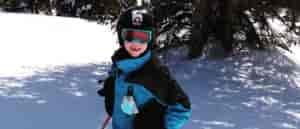 Photo of young boy tree skiing.