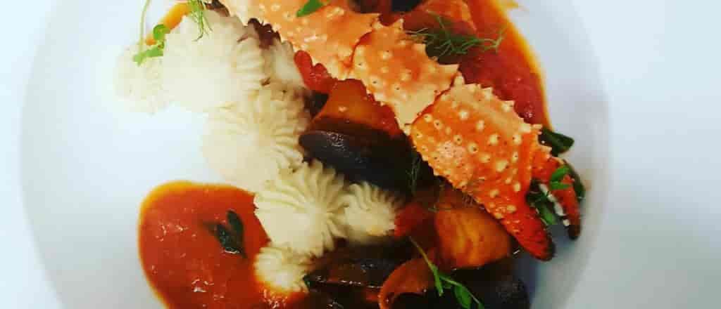 photo of crab leg and pasta.
