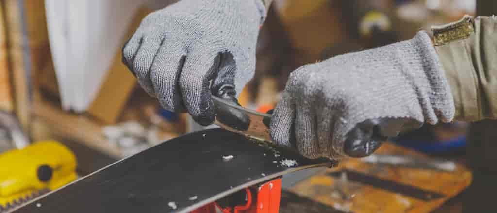 Close up of person waxing a board.