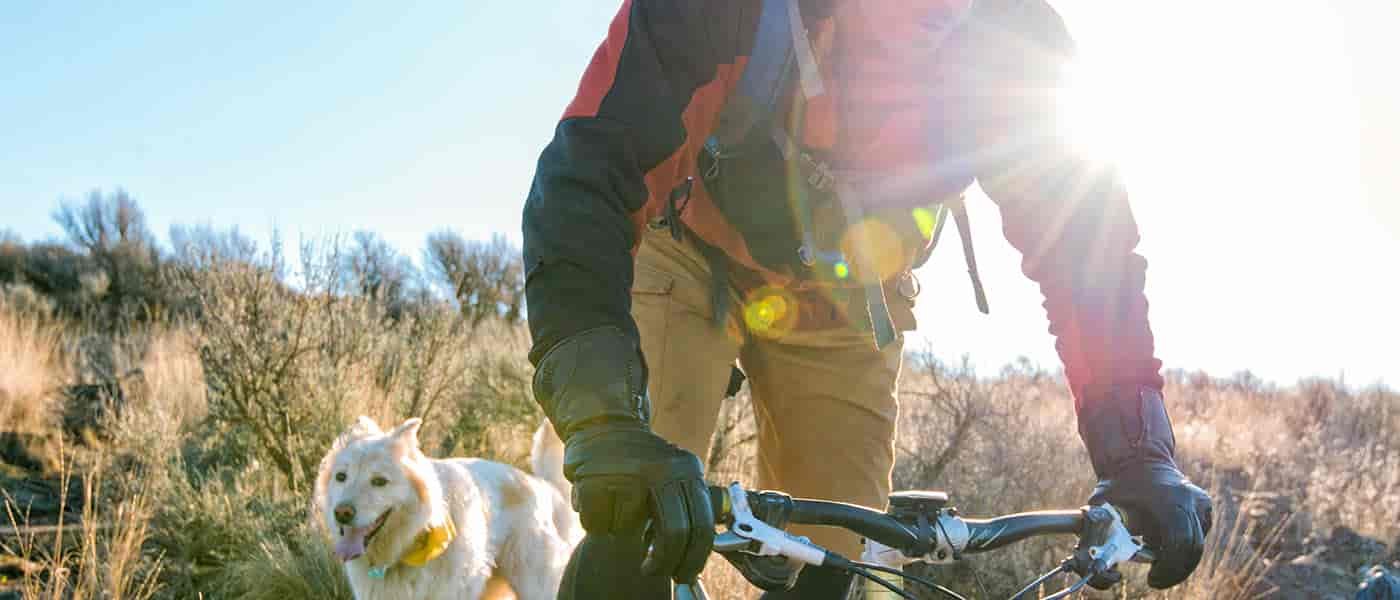Photo of mountain biker and his dog.