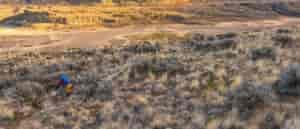 Photo of mountain biker riding through the Scablands taken from above.