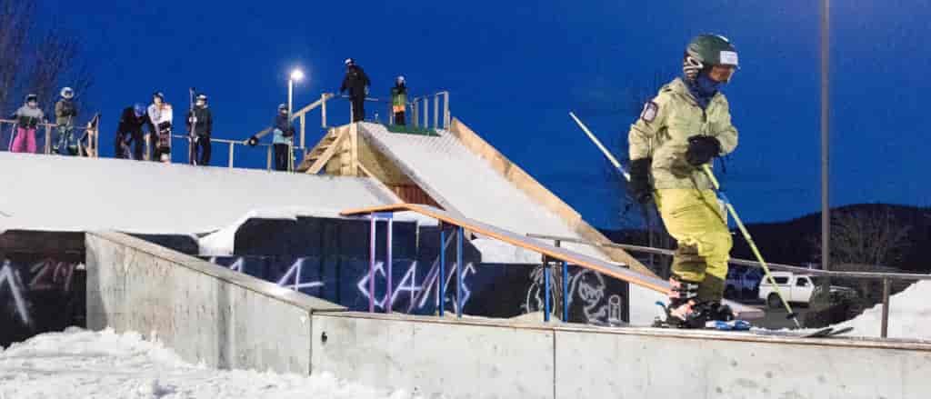 Photo of skier on rail.