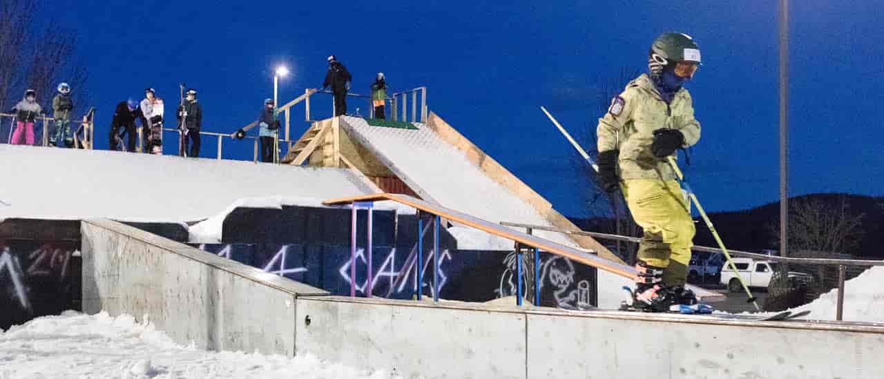 Photo of skier on rail.