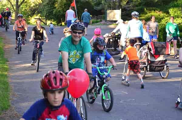 Photo of kids and adults biking along the Centennial Trail.