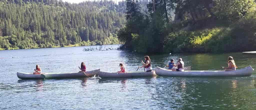 Photo of three canoes on the river.