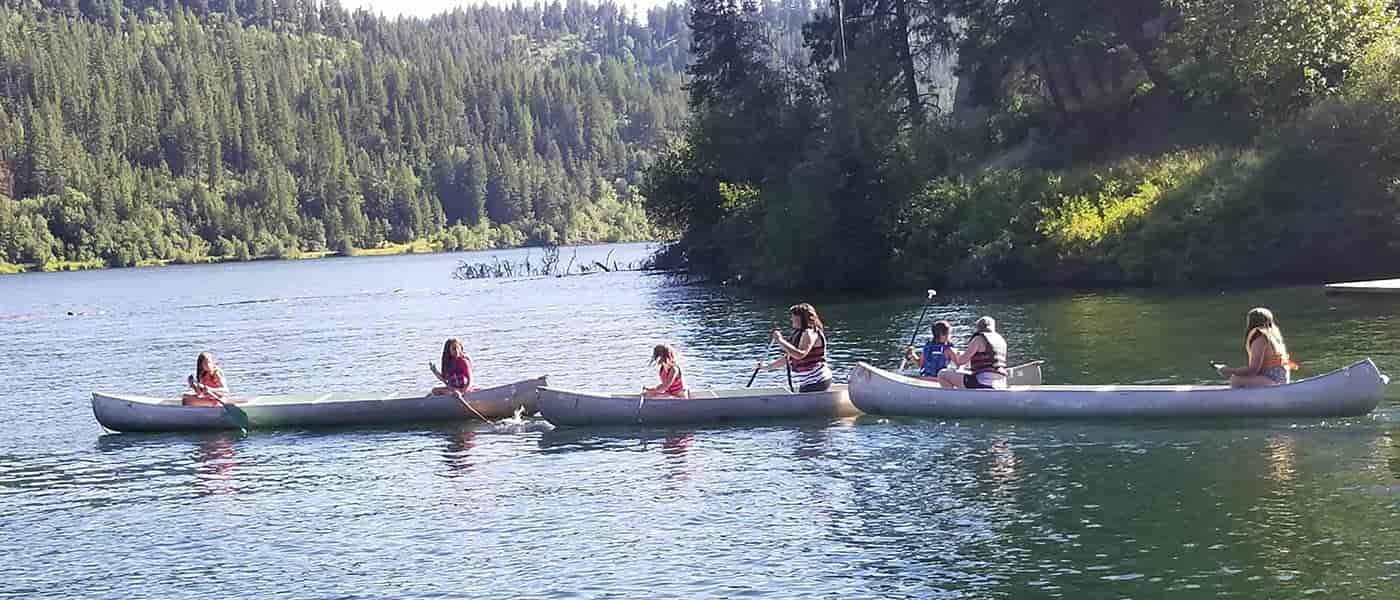 Photo of three canoes on the river.