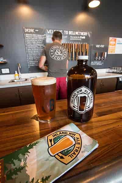 Photo of growler and beer taken at the bar in Bellweather Brewing