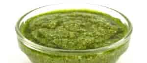 Photo of wild greens pesto in glass dipping bowl.
