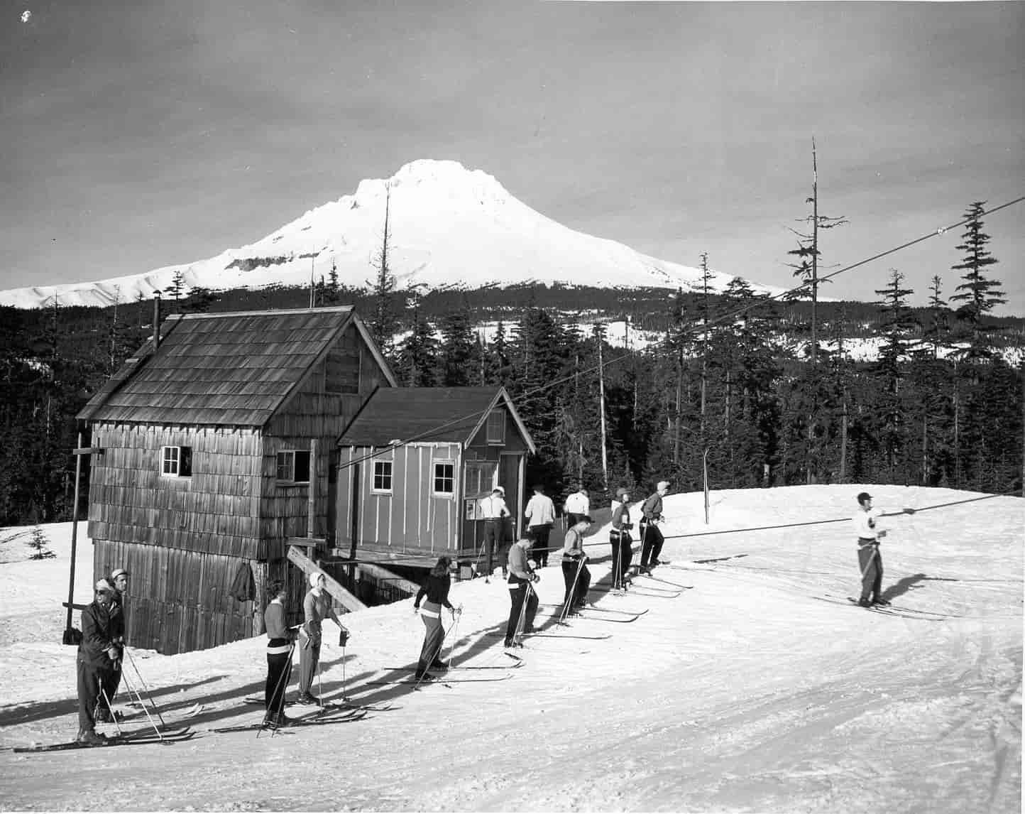 A old black and white vintage photo of people skiing.