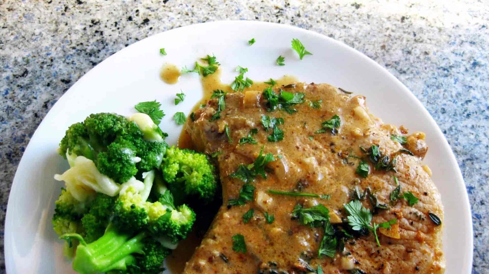 A close-up of pork and broccoli.