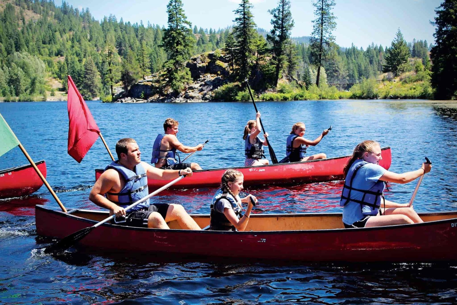 A group of kids canoeing.