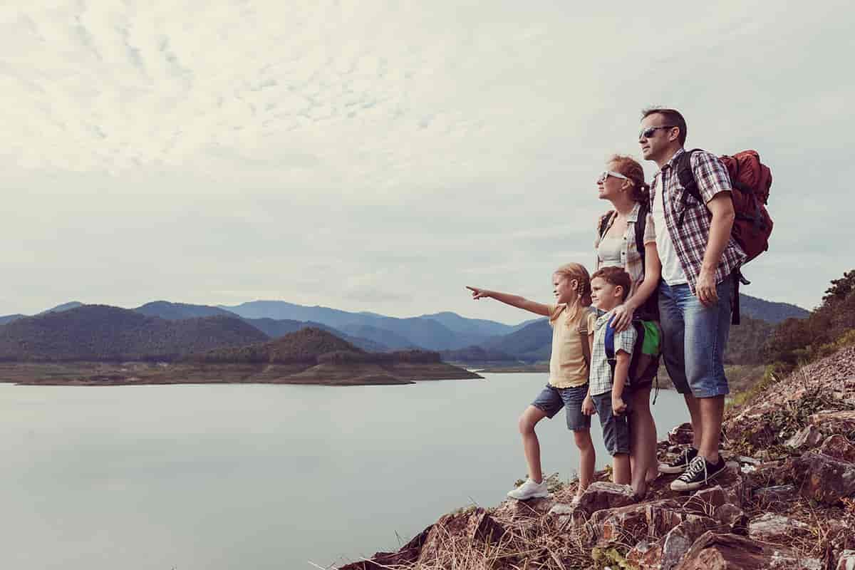 A family hiking along a lake.