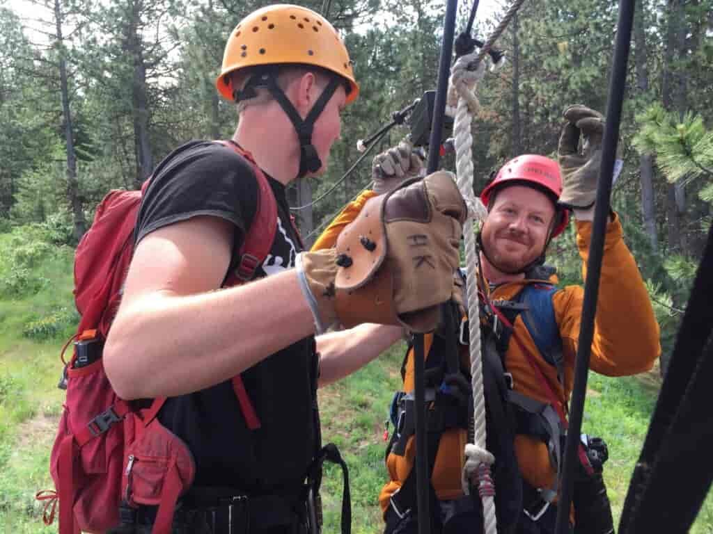 Two people getting ready to zipline.