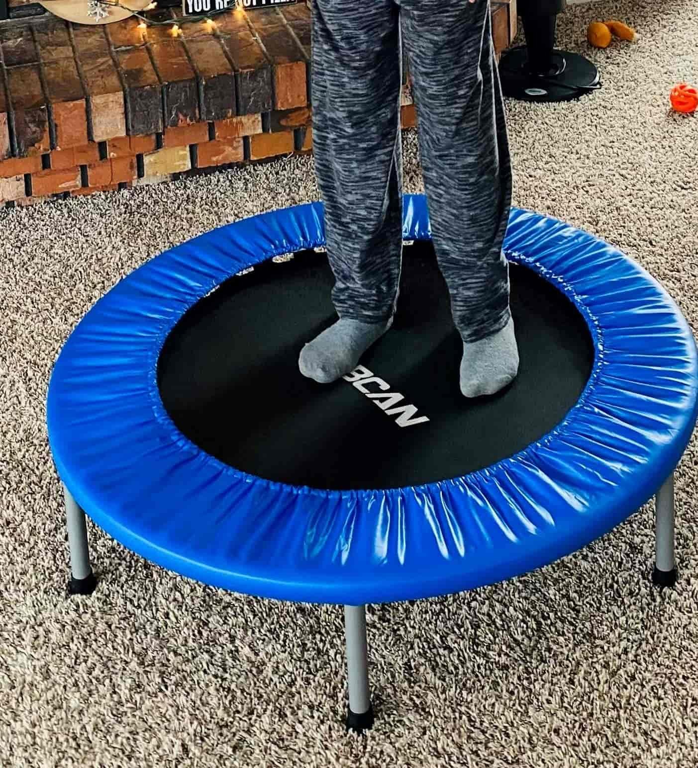 Boy jumping on a mini trampoline close-up.