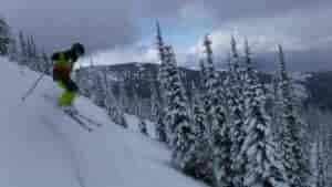 Person skiing down mountain.