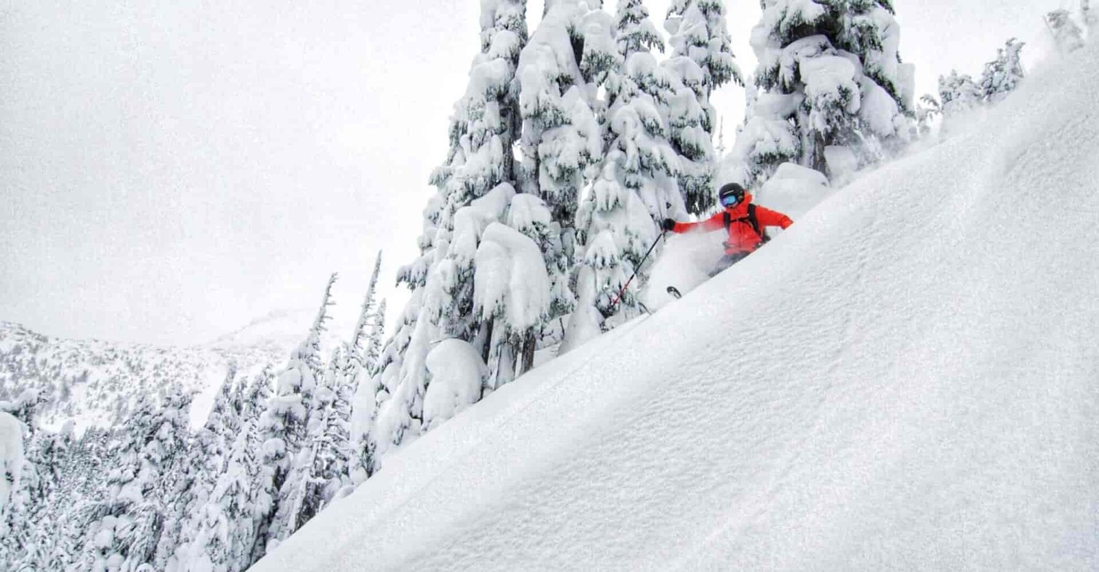 A Rippin Chix skier goes down a steep and deep run.