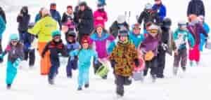 Ski kids racing through the snow.