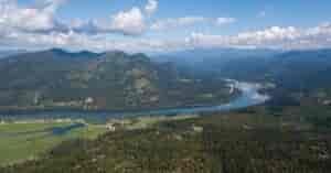 Aerial view of the Pend Oreille River valley, with forested hillsides.