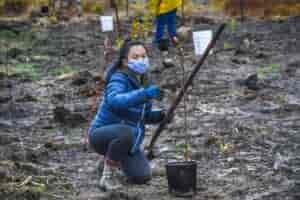 Woman at the tree planting event holding a shovel.
