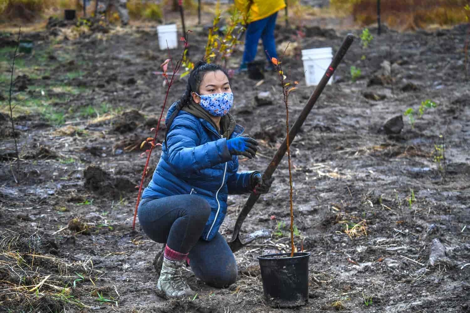 Woman at the tree planting event holding a shovel.
