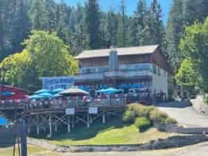 Conkling Marina and Resort featuring large elevated dining deck with table umbrellas and lodge with wraparound deck-balcony.